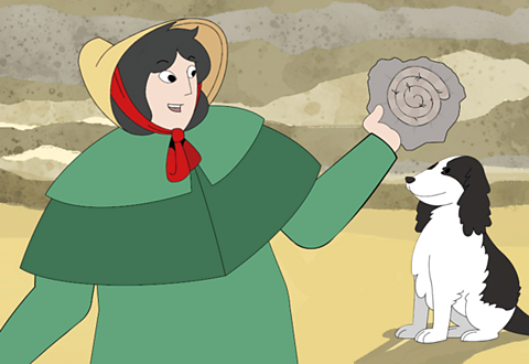 Mary Anning with her dog on the beach holding up a fossil