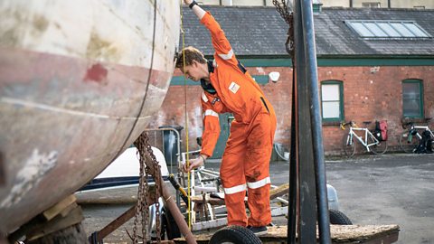 Lawrence measuring a boat.