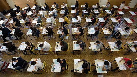 Getty Images Essay mills have become more popular worldwide, as has university exam fraud. Pictured here are French high school students sitting an exam in 2018 (Credit: Getty Images)