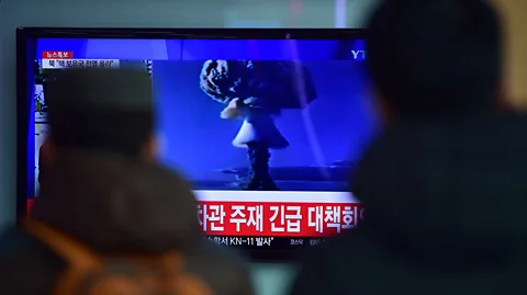 Getty Images Passers-by watch the broadcast of a nuclear weapon test in North Korea (Credit: Getty Images)