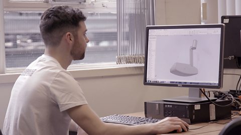 Michael working on a golf putter design at the computer.