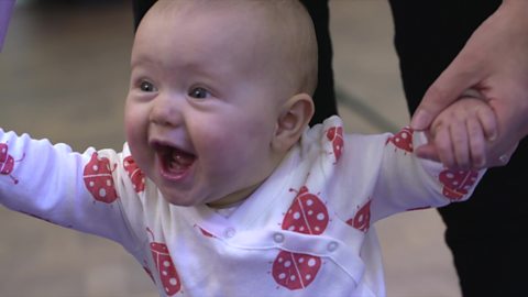 A baby looking really excited.