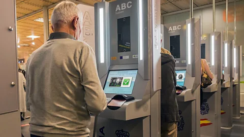 Alamy Automatic passport control kiosks are now common at many airports but they could soon also interrogate passengers as they try to pass through (Credit: Alamy)