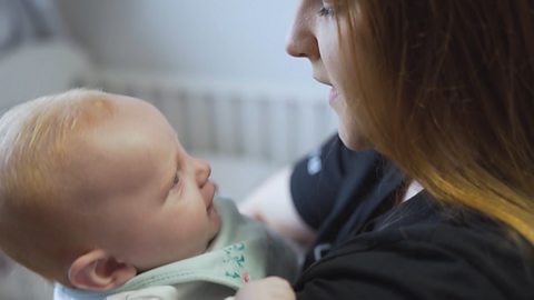 A mum sings to her baby