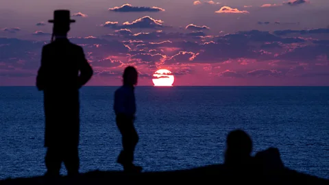 Getty Ultra-Orthodox Jewish men take part in the Tashlich ritual, during which sins are cast into the water to the fish (Credit: Getty)