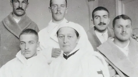 Alamy Gedroits is photographed with her patients. Unlike many of her colleagues, she did not shy away from difficult operations to the abdomen (Credit: Alamy)