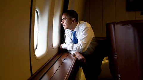 President Barack Obama looks out a window of Air Force One (White House Photo/Alamy)