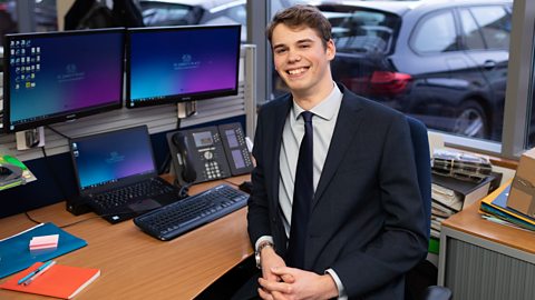 Ben sat in front of his desk at work