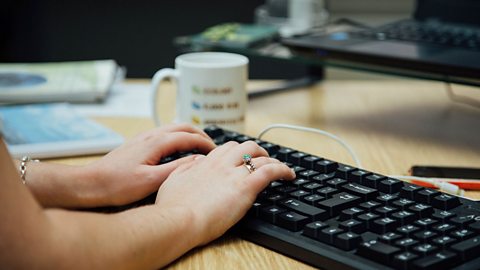 Gabby at work, typing on her keyboard.