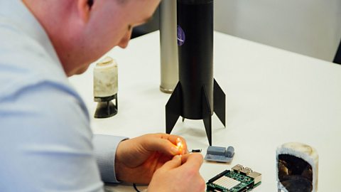 Ben uses computer software to test rockets.