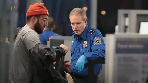 Getty Images A Transportation Security Administration (TSA) worker screens passengers and airport employees at Chicago’s O'Hare International Airport (Credit: Getty Images)