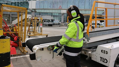 Shannon guiding a baggage handling conveyor into place.