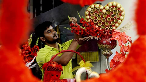 Getty Images A florist in India preps a display earlier this year for Valentine's Day. Florists are highly trained, and their artistry is a factor that deteremines price (Credit: Getty Images)