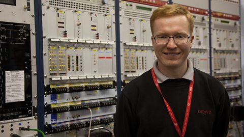 Harry Higgs smiling to camera in his lab.