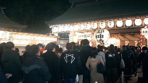 Edd Gent Locals in Fukuoka attend a festival at the Toka Ebisu shrine and pray for good luck and success in business in the year to come (Credit: Edd Gent)