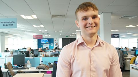 William smiling at the camera in the office.