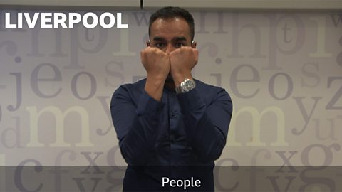 Esmail Patel shows the sign for 'people' in British Sign Language (Liverpool version)