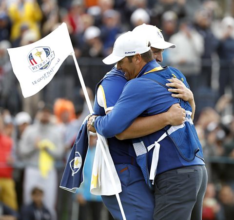 Jon Rahm of Spain celebrates with his caddie after Europe Team win on the final day of the Ryder Cup 2018