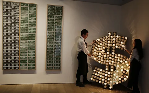 Getty Images Artwork made from reflector caps, lamps and an electronic sequencer, by artists Tim Noble and Sue Webster alongside pieces by Andy Warhol (Credit: Getty Images)