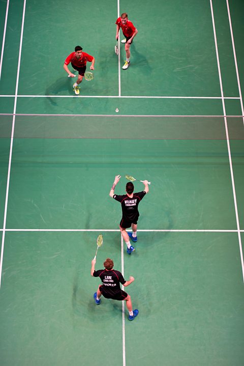 Photo of a men's doubles badminton match