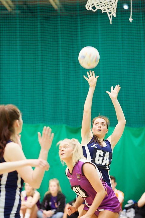 Photo of a goal shoot trying to score in netball