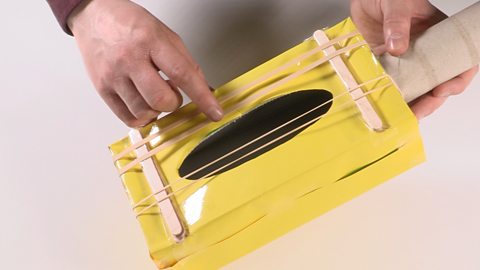 Make a tissue box guitar for your toddler