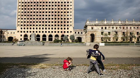Former Abkhazian parliament and children playing