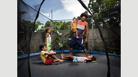 Gabriele Galimberti/INSTITUTE Because Michael Chamorro Suarez works nights at his pizzeria in Cahuita, Costa Rica, he can spend time with his children during the day (Credit: Gabriele Galimberti/INSTITUTE)