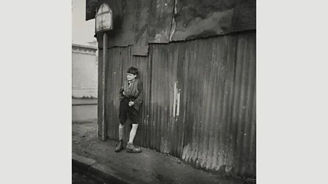 Centre Pompidou Maar expressed her left-wing ideology in her street photography, such as Sans titre, 1933, a portrait of a boy leaning against a corrugated iron wall (Credit: Centre Pompidou)
