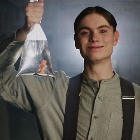 Photograph of boy holding a goldfish