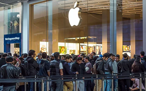 Alamy Apple fans camp out ahead of new product launches - numbered wristbands mark their place in line and some are allowed to leave for up to one hour for meal breaks (Credit: Alamy)