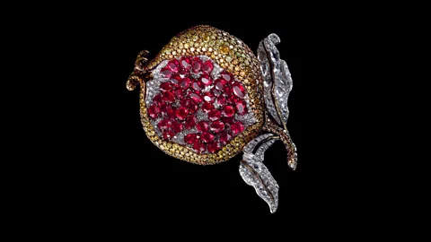 2018 Carnet Jewelry The Precious Pomegranate brooch by Ong is created with rubies, and brown, white and gold diamonds in white and yellow gold (Credit: 2018 Carnet Jewelry)