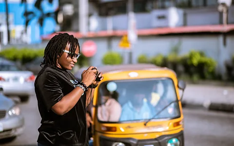 Faith Ilevbare Professional photographer Grace Ekpu says she packs water, cranks up the AC and bypasses moisturisers to avoid sweating and overheating (Credit: Faith Ilevbare)