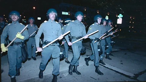 Alamy Scores of police in riot gear during the second night of disturbances by students at Virginia Beach, Virginia, on 4 September 1989 (Credit: Alamy)