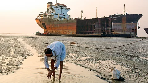 Getty Images Oil tankers sent for scrapping are often run aground on beaches in Bangladesh where they are dismantled by hand by poorly paid unskilled workers (Credit: Getty Images)