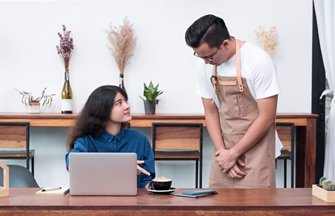 A waiter listening to a customer complaint
