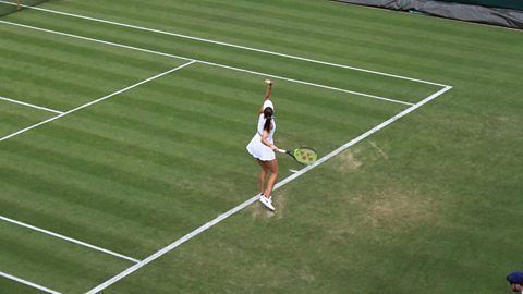 Tennis player serving at Wimbledon