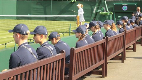 Ball boys and ball girls sitting in a line