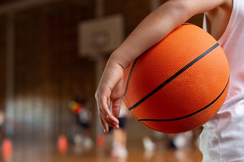 Boy holding basketball.