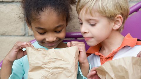 Boy and girl looking in a bag