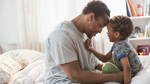 Dad talking to son at bedtime