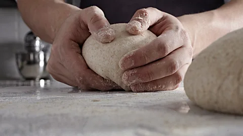 Getty Images Could the biome on a baker's hands be influencing the texture and taste of the dough? (Credit: Getty Images)
