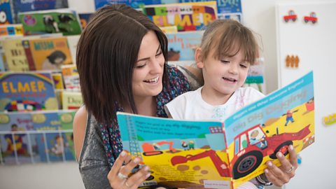 Child reading with mother