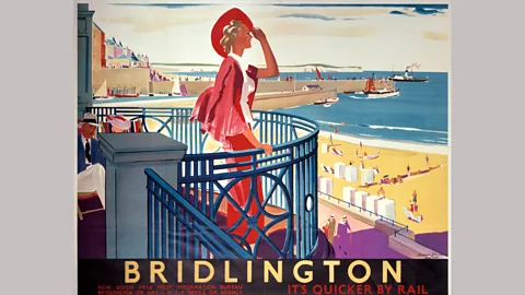 Getty Images An elegant holidaymaker features in a 1930s poster promoting rail travel to the UK resort of Bridlington (Credit: Getty Images)