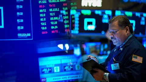 Getty Images A man in the Wall Street stock exchange (Credit: Getty Images)