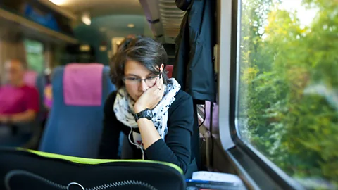 Getty Images woman commuter train laptop