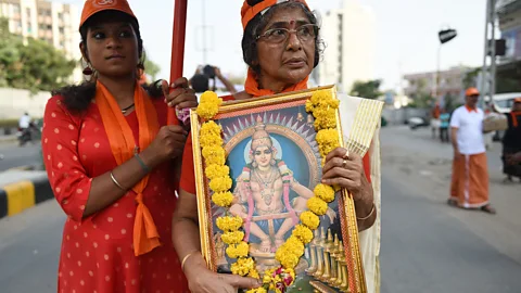 Getty Religious devotees protested against India’s decision to revoke a ban on women aged between 10 and 50 entering a Hindu temple in Kerala (Credit: Getty)