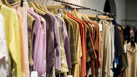 Second hand clothes on a clothes rack. 