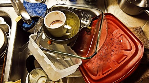A sink full of empty dirty dishes.