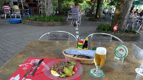 Larry Bleiberg A line across Restaurant Waldheim’s outdoor terrace marks the international border, making it possible to dine in two countries at once (Credit: Larry Bleiberg)